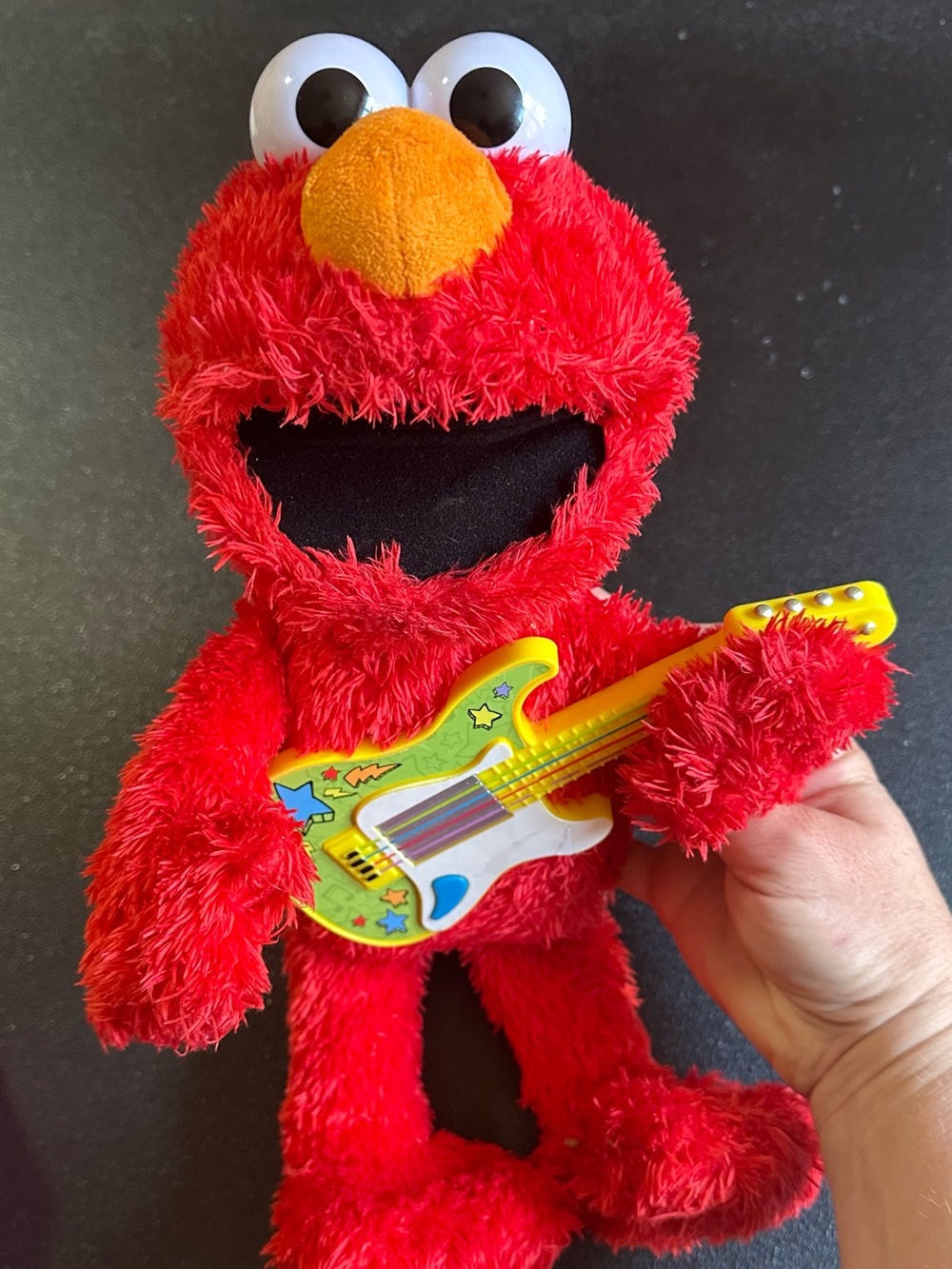 Sesame Street Elmo Red Plush with Yellow Guitar. Works well.
